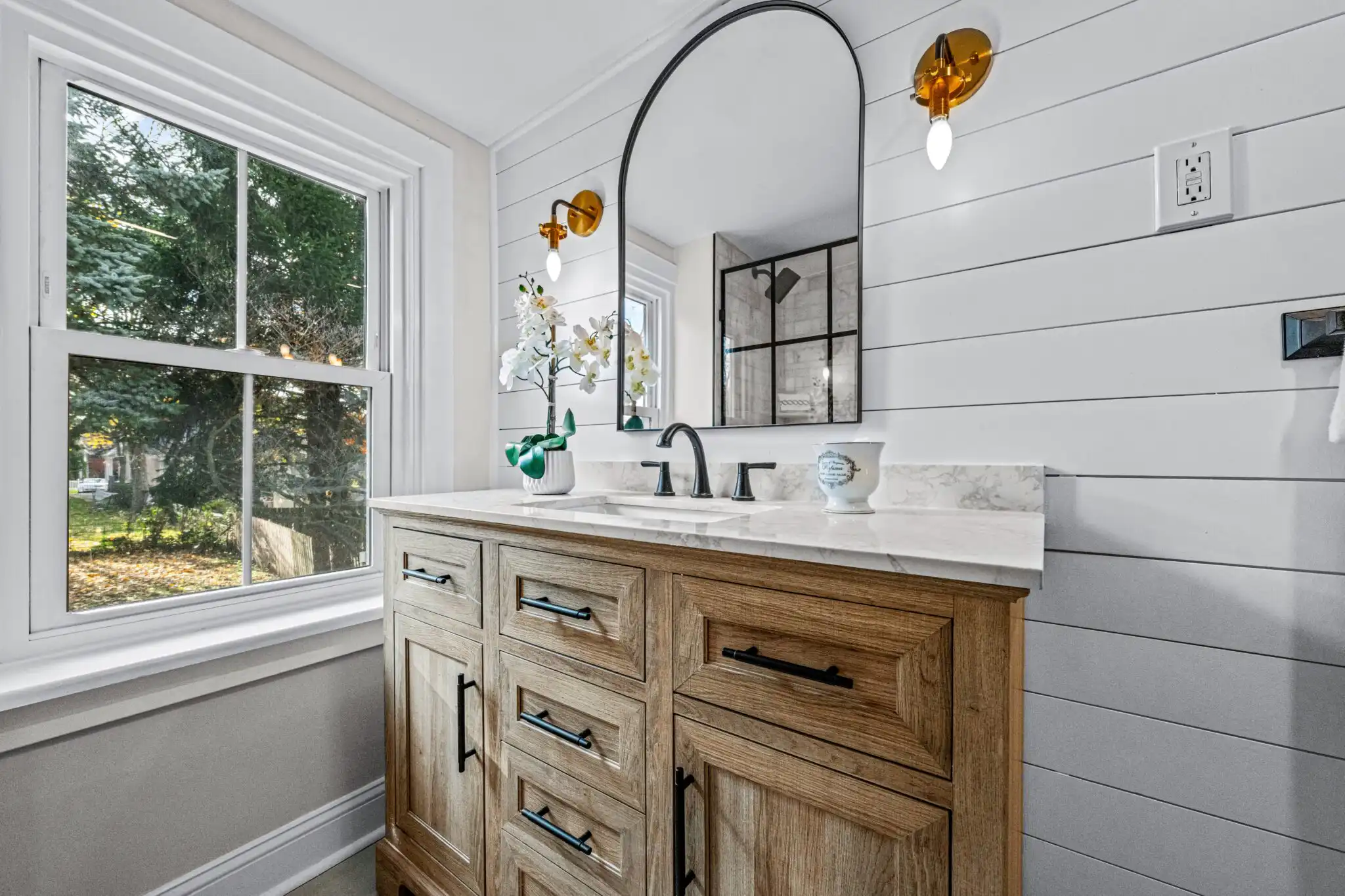 newly renovated bathroom with updated vanity, plumbing, and flooring.